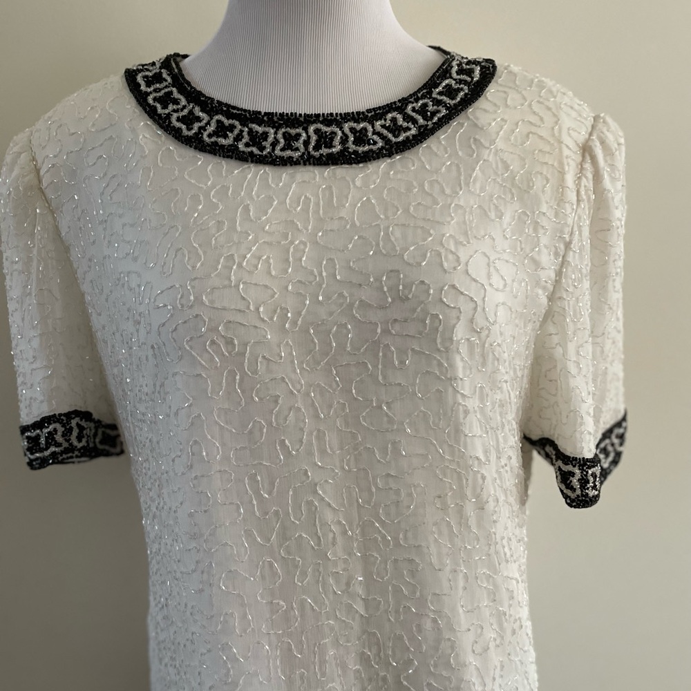 Evening beaded white silk blouse with black and white beads design.